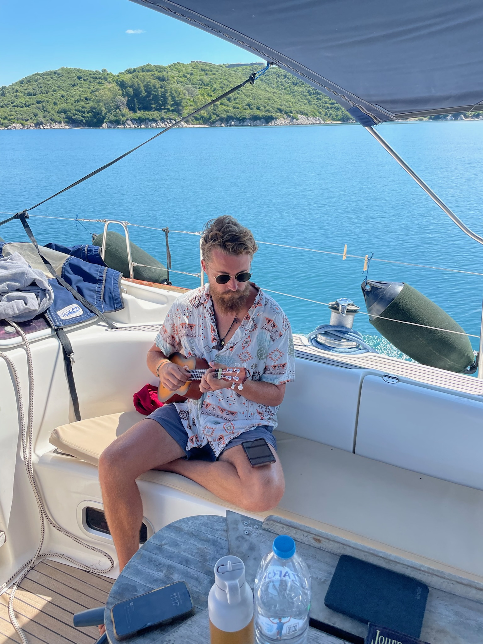 James playing ukulele on a sailing trip