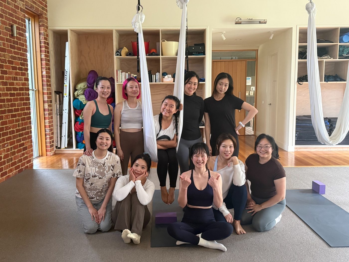 Friends at an aerial yoga class
